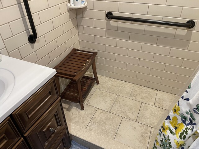 bathroom featuring tile walls, vanity, and tile patterned flooring