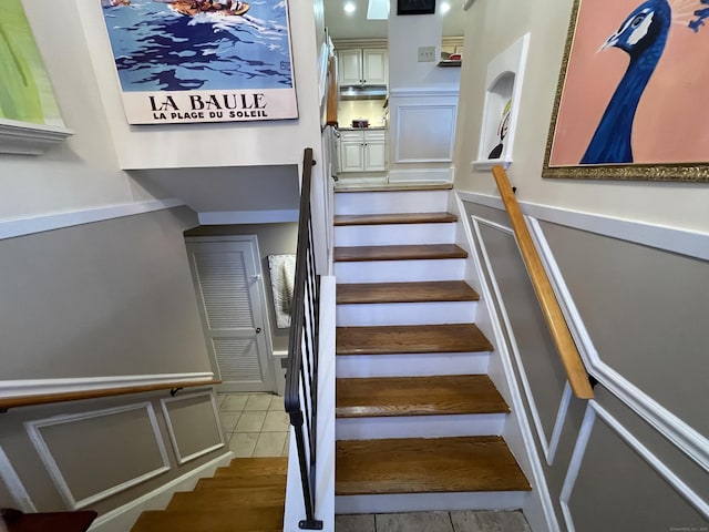 stairs featuring tile patterned flooring