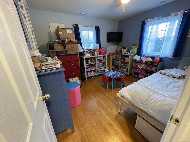 bedroom with ceiling fan and light wood-type flooring