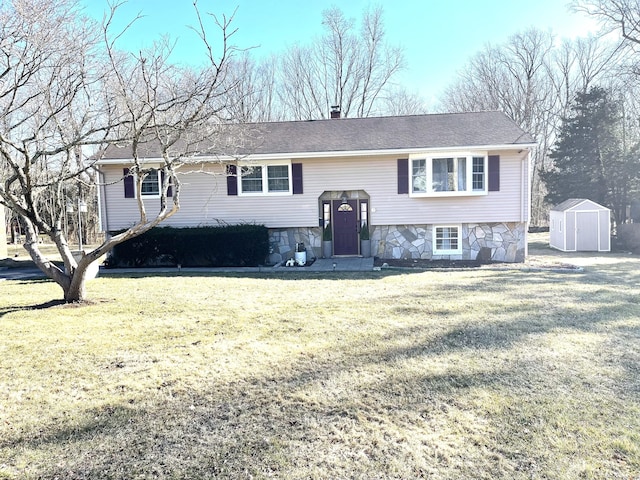 raised ranch featuring stone siding, a chimney, an outbuilding, a shed, and a front lawn