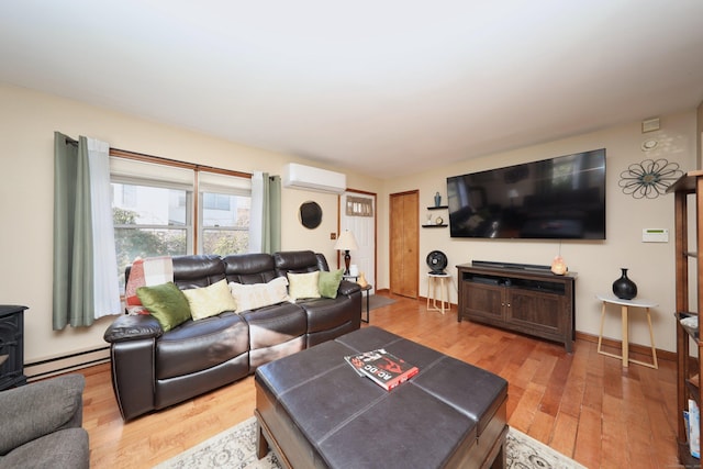 living room featuring baseboard heating, hardwood / wood-style floors, and a wall mounted air conditioner