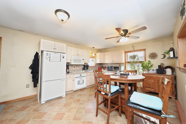 kitchen with ceiling fan, white appliances, hanging light fixtures, and tasteful backsplash