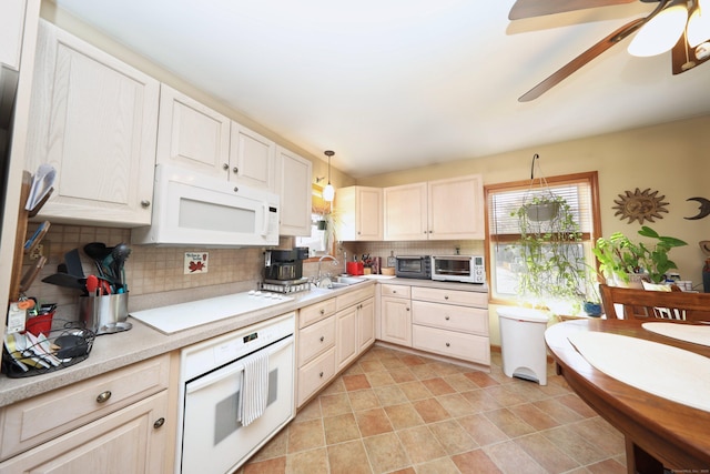 kitchen featuring white appliances, tasteful backsplash, hanging light fixtures, and sink