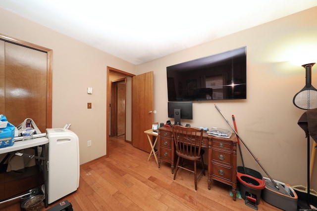 home office with light hardwood / wood-style floors