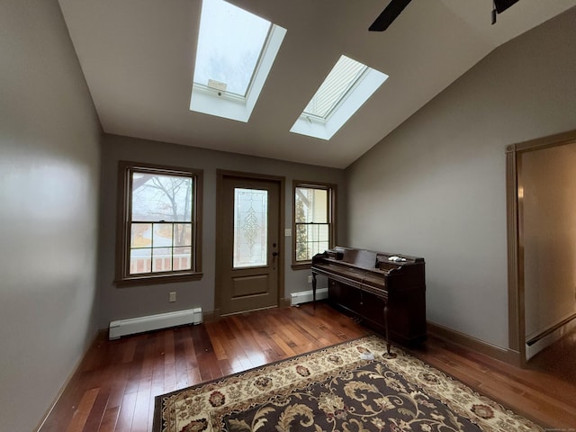 foyer entrance featuring dark wood-type flooring, a wealth of natural light, and a baseboard heating unit