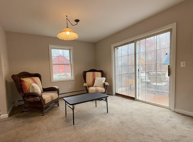 sitting room featuring a baseboard radiator and light colored carpet