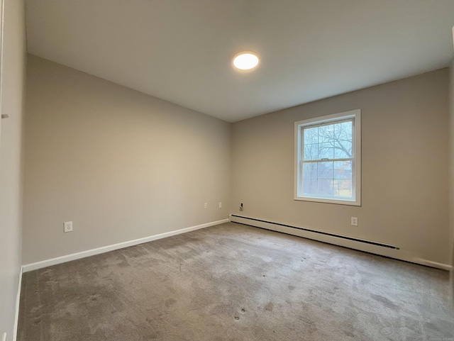 empty room with carpet and baseboard heating