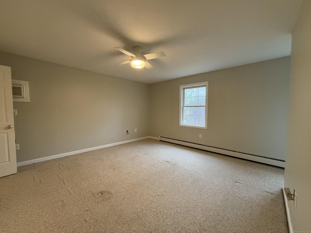 spare room featuring ceiling fan, carpet floors, and a baseboard radiator