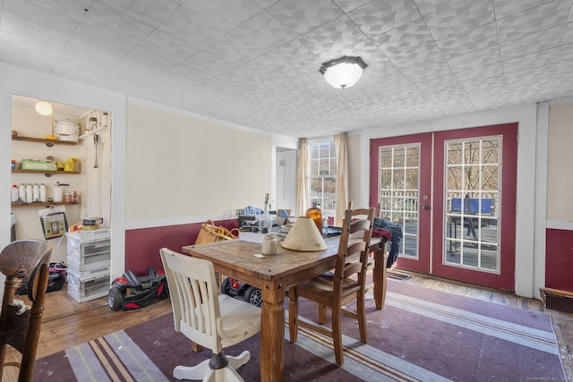 dining space with hardwood / wood-style floors and french doors