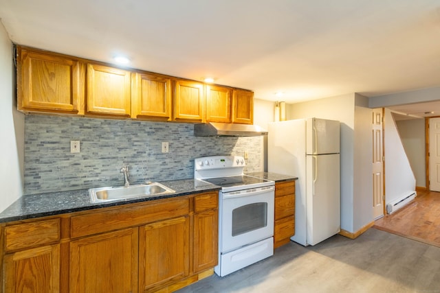 kitchen featuring light wood-type flooring, tasteful backsplash, white appliances, a baseboard heating unit, and sink