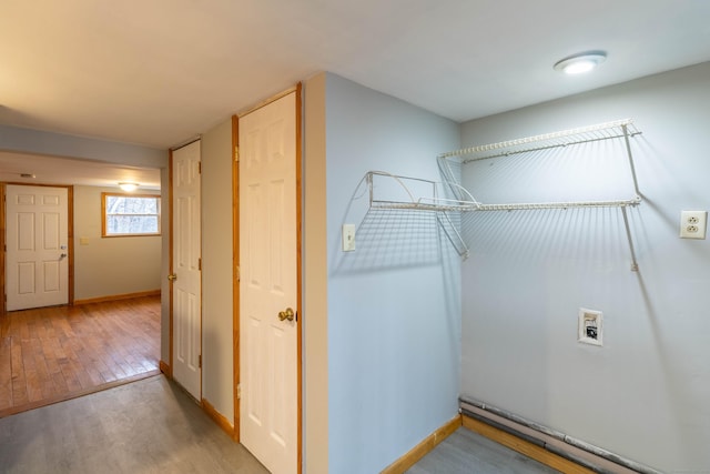 laundry area featuring hookup for a washing machine and light hardwood / wood-style flooring