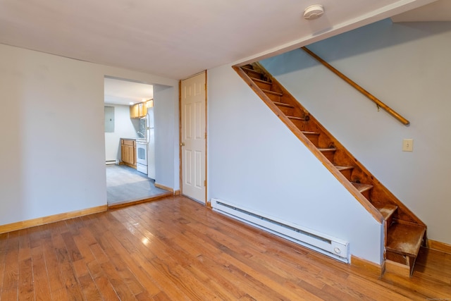 interior space with baseboard heating and light hardwood / wood-style floors