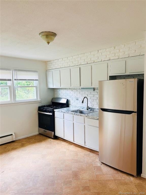 kitchen with white cabinetry, sink, stainless steel appliances, a baseboard radiator, and decorative backsplash