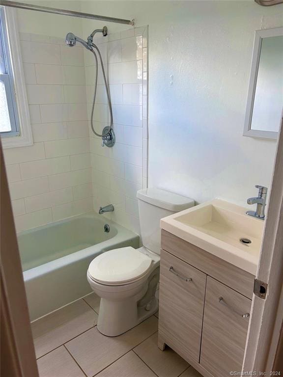 full bathroom with tile patterned floors, vanity, toilet, and tiled shower / bath