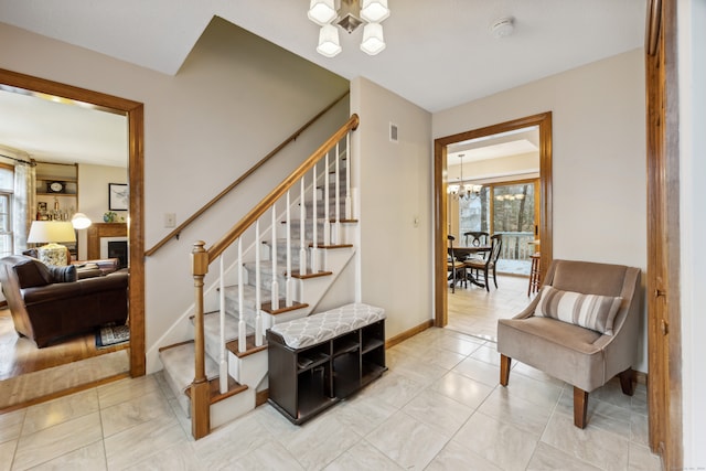 stairs featuring tile patterned floors and a chandelier