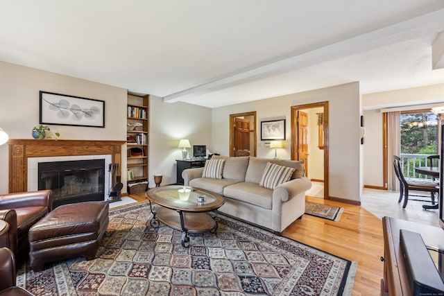 living room featuring hardwood / wood-style floors and a tiled fireplace