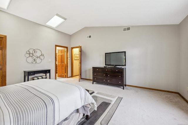 bedroom featuring light carpet and vaulted ceiling with skylight