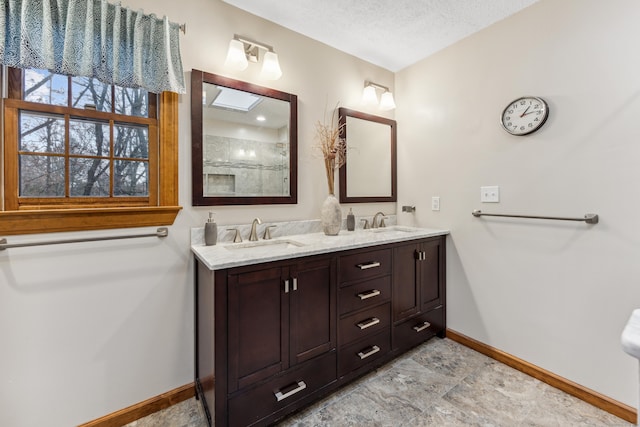 bathroom with vanity and a textured ceiling