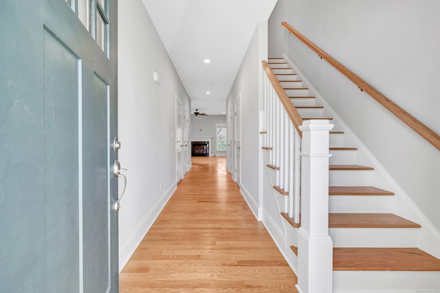 entrance foyer featuring ceiling fan and light wood-type flooring