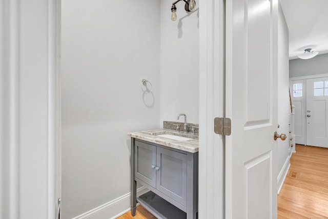 bathroom with hardwood / wood-style floors and vanity