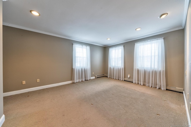 carpeted spare room featuring crown molding and a baseboard heating unit