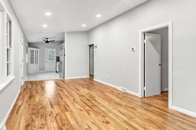 unfurnished living room featuring ceiling fan and light hardwood / wood-style flooring