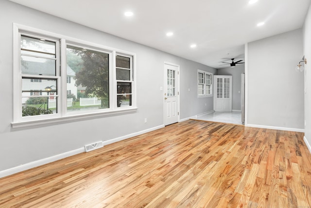 unfurnished room featuring ceiling fan and light hardwood / wood-style floors