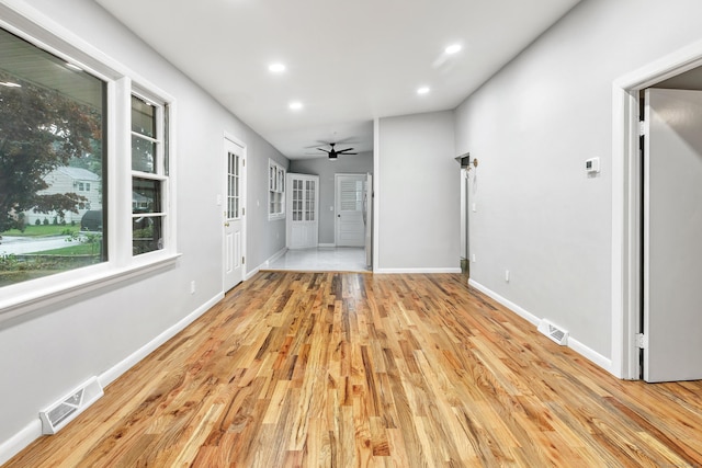 unfurnished living room featuring light wood-type flooring and ceiling fan