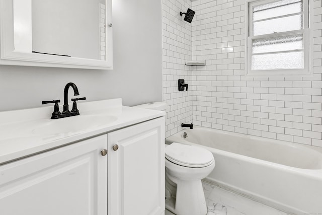 full bathroom with vanity, toilet, and tiled shower / bath