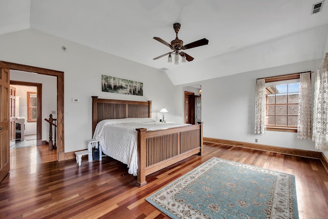 bedroom featuring dark hardwood / wood-style flooring, vaulted ceiling, and ceiling fan