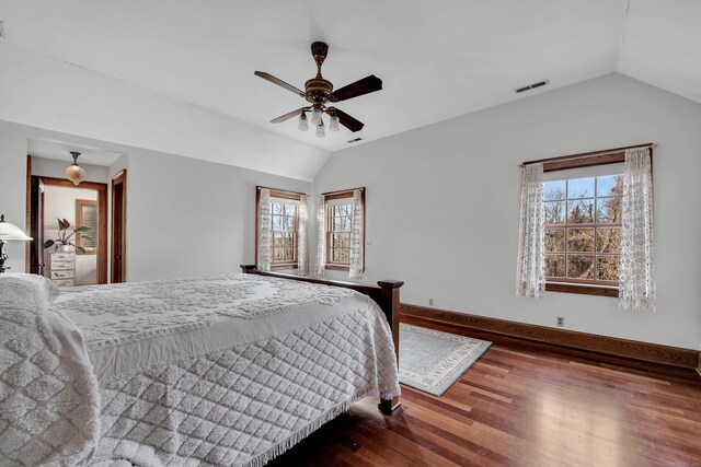 bedroom featuring vaulted ceiling, visible vents, baseboards, a ceiling fan, and wood finished floors