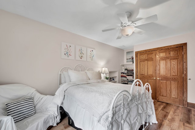 bedroom with ceiling fan, a closet, and light wood-type flooring