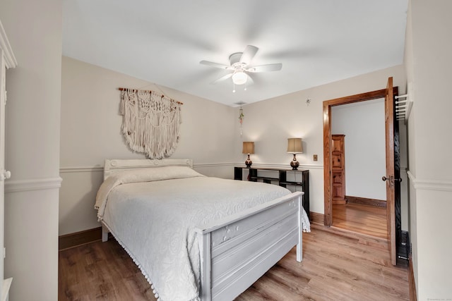 bedroom with hardwood / wood-style floors and ceiling fan