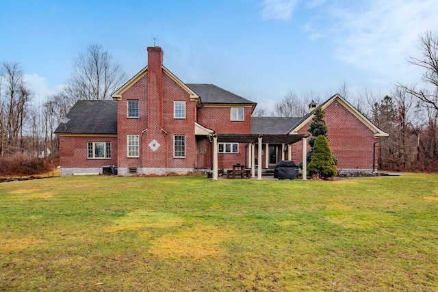 back of house featuring a yard