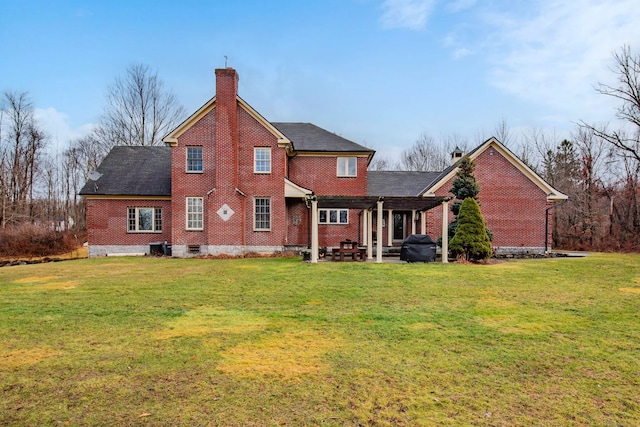 rear view of house featuring a lawn, a chimney, crawl space, and a patio