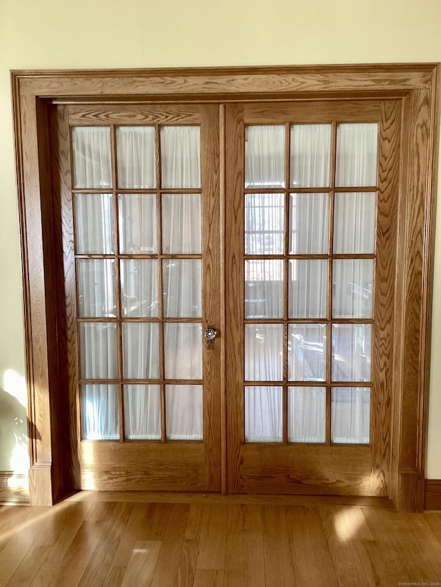 entryway featuring hardwood / wood-style floors and french doors