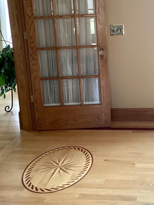 entryway with wood finished floors