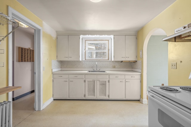 kitchen with white cabinets, white electric range, radiator heating unit, and sink