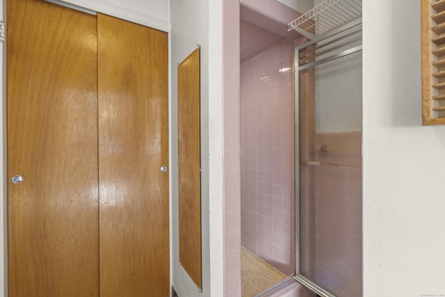 bathroom featuring a shower with door