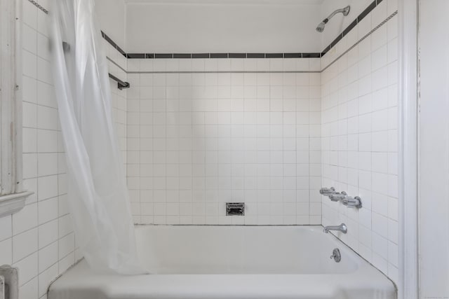 bathroom with shower / bath combo with shower curtain