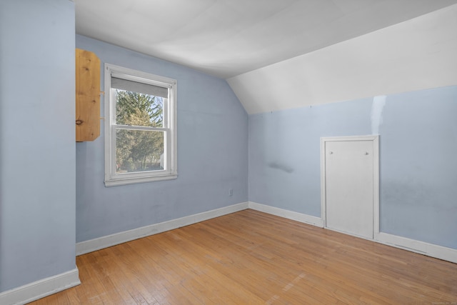 bonus room featuring light hardwood / wood-style floors and vaulted ceiling