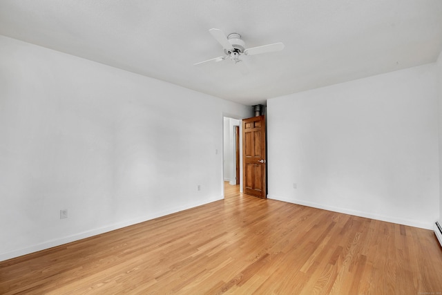 unfurnished room with light wood-type flooring, baseboard heating, and ceiling fan