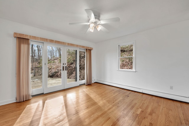 empty room with french doors, light wood-type flooring, baseboard heating, and ceiling fan