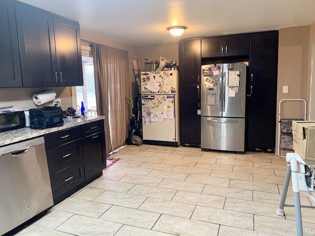 kitchen featuring light stone countertops and stainless steel appliances