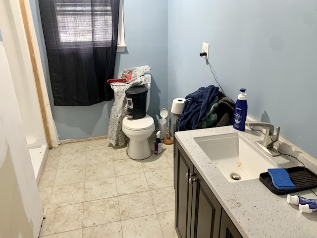 bathroom featuring tile patterned floors, vanity, and toilet