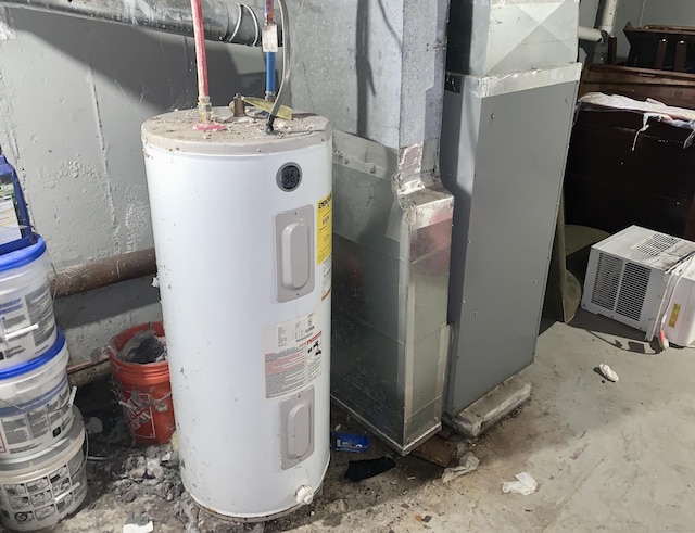 utility room with electric water heater and heating unit