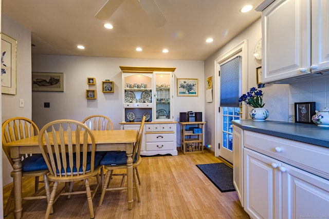 dining room with ceiling fan and light hardwood / wood-style flooring