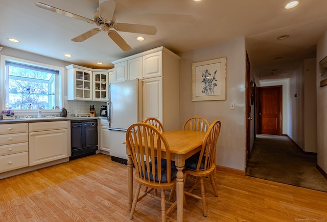 dining area featuring ceiling fan, light hardwood / wood-style floors, and sink