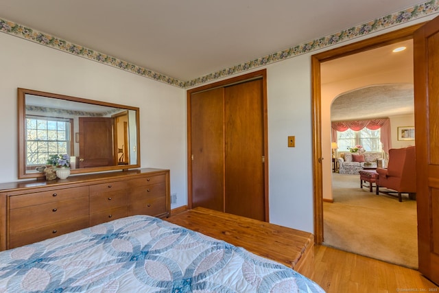 bedroom with a closet and light hardwood / wood-style floors