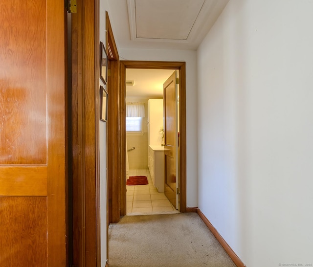 hall featuring light colored carpet